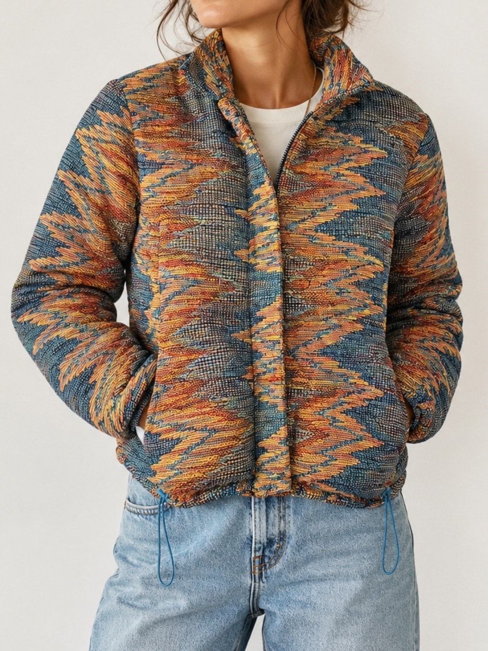 multi colored patterned jacket with blue interior and drawstring waist